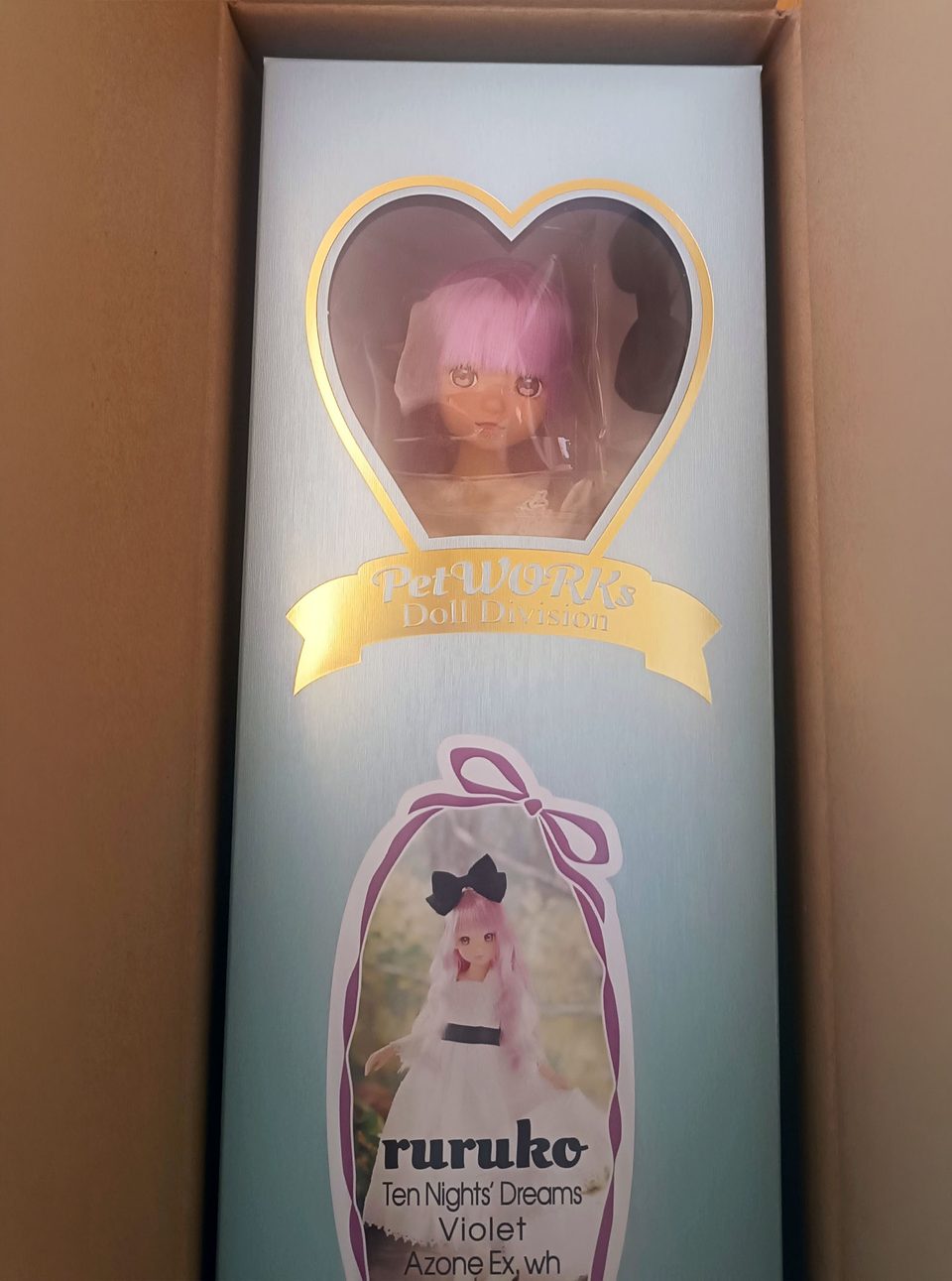 Ruruko doll in the box. The box has a heart shaped window to see her face.
