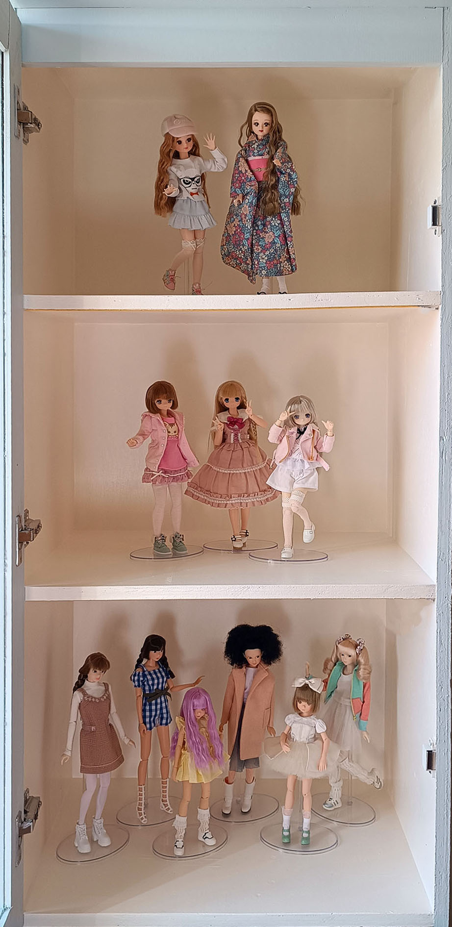 My cabinet display full of dolls.