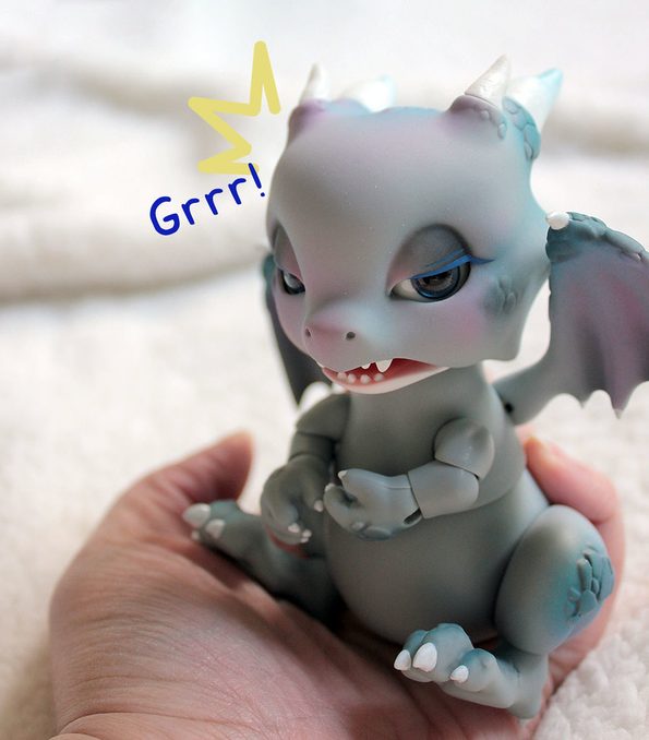 Grey dragon with blue and pink make up.