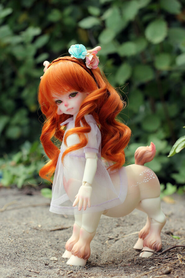 Deertaur BJD with carrot red hair and green eyes.